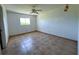 Bright bedroom with neutral walls, tile floors, and ceiling fan, creating a peaceful retreat at 12143 Du Barry Ave, Port Charlotte, FL 33981