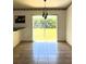 Bright dining room with tile floors, chandelier, and sliding glass doors leading to the backyard at 12143 Du Barry Ave, Port Charlotte, FL 33981