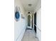 Welcoming entryway featuring tiled floors, decorative wall art, and a front door with a glass window at 12143 Du Barry Ave, Port Charlotte, FL 33981