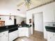 Open kitchen features a breakfast bar, white cabinetry, and a tiled backsplash, providing ample workspace at 12143 Du Barry Ave, Port Charlotte, FL 33981