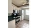Kitchen featuring white cabinets, tiled floor, and modern appliances, providing efficient meal preparation at 12143 Du Barry Ave, Port Charlotte, FL 33981