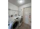 Laundry room features a washer and dryer, with shelving above at 12143 Du Barry Ave, Port Charlotte, FL 33981