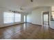 Bright, spacious living room with tiled floors, neutral walls, ceiling fan, and natural light at 12143 Du Barry Ave, Port Charlotte, FL 33981