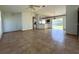 Open-concept living room boasts tile flooring and natural light, perfect for modern living and entertaining at 12143 Du Barry Ave, Port Charlotte, FL 33981