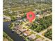 Waterfront property with canal access, lush landscaping, and proximity to amenities at 13707 Begonia Cir, Port Charlotte, FL 33981