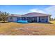 Expansive backyard with a screened-in patio, perfect for outdoor entertaining and relaxation at 17220 Horizon Ln, Port Charlotte, FL 33948