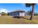 Well-maintained home exterior with a lush lawn, showcasing its appealing architectural design at 17220 Horizon Ln, Port Charlotte, FL 33948