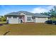 Inviting home exterior, displaying a tidy lawn, ample parking, and an attractive facade at 17220 Horizon Ln, Port Charlotte, FL 33948