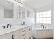 Bright bathroom featuring double sink vanity with marble countertop and white cabinets at 193 Beeney Se Rd, Port Charlotte, FL 33952