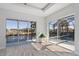 Bright bedroom with sliding glass doors leading to screened patio with water and pool views at 193 Beeney Se Rd, Port Charlotte, FL 33952