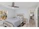 Comfortable bedroom featuring a ceiling fan, a window providing plenty of light, and neutral tones at 193 Beeney Se Rd, Port Charlotte, FL 33952