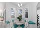 Bright breakfast nook with banquette seating and three large windows at 193 Beeney Se Rd, Port Charlotte, FL 33952