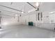 Spacious three car garage featuring light gray flooring and lots of extra storage space at 193 Beeney Se Rd, Port Charlotte, FL 33952