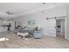 Bright living room with wood floors, tray ceilings, modern decor and sliding barn door at 193 Beeney Se Rd, Port Charlotte, FL 33952