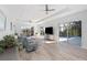 Open concept living room with access to lanai, tray ceilings, wood floors, and abundant natural light at 193 Beeney Se Rd, Port Charlotte, FL 33952