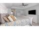 Spacious primary bedroom with a tray ceiling, ceiling fan, and stylish decor at 193 Beeney Se Rd, Port Charlotte, FL 33952