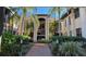 Charming courtyard entrance with lush landscaping and brick pathway leads to residences at 23465 Harborview Rd # 1006, Punta Gorda, FL 33980