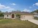 Charming single-story home with a well-manicured lawn, driveway, and attached two-car garage at 4557 Sabrina Ter, North Port, FL 34286