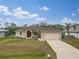 Charming single-story home with a well-manicured lawn, a driveway, and a two-car garage at 4557 Sabrina Ter, North Port, FL 34286