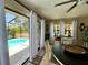 Bright dining room with view of the pool, white curtains, and elegant decor creating a cozy atmosphere at 1434 Viscaya Dr, Port Charlotte, FL 33952