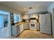 Well-lit kitchen featuring tile flooring, updated appliances, and wood counters at 1434 Viscaya Dr, Port Charlotte, FL 33952