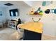 Bright kitchen island with butcher block top with bar stool seating and decorative fish wall art at 1434 Viscaya Dr, Port Charlotte, FL 33952