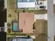 Aerial view of a waterfront property featuring a private pool, dock, backyard landscaping, and charming curb appeal at 164 Chelsea Nw Ct, Port Charlotte, FL 33952