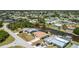 Aerial view of waterfront home with a private dock, lush landscaping, and a serene canal setting at 164 Chelsea Nw Ct, Port Charlotte, FL 33952