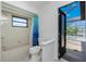 Bathroom with an open door offering a view of the backyard pool at 164 Chelsea Nw Ct, Port Charlotte, FL 33952