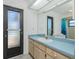 Bathroom vanity with a dark door leading to the outside at 164 Chelsea Nw Ct, Port Charlotte, FL 33952