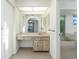 Vanity area leading to the bathroom with a bathtub and bright window at 164 Chelsea Nw Ct, Port Charlotte, FL 33952