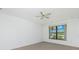 Bedroom featuring a ceiling fan and a view of the outside landscape at 164 Chelsea Nw Ct, Port Charlotte, FL 33952