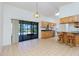 Open dining area with tile flooring, breakfast bar, and sliding glass doors to the pool at 164 Chelsea Nw Ct, Port Charlotte, FL 33952