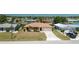 Well-maintained waterfront home featuring a spacious driveway and mature landscaping at 164 Chelsea Nw Ct, Port Charlotte, FL 33952