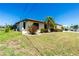 Beautiful home featuring a lush lawn, manicured bushes and a tasteful exterior at 164 Chelsea Nw Ct, Port Charlotte, FL 33952