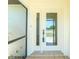 Close-up of a well-maintained front entry door with decorative glass and secure access at 164 Chelsea Nw Ct, Port Charlotte, FL 33952