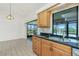 The Kitchen is bright with stainless steel appliances and natural wood cabinets at 164 Chelsea Nw Ct, Port Charlotte, FL 33952