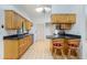 Kitchen features wood cabinets, black countertops, stainless steel appliances, and a breakfast bar at 164 Chelsea Nw Ct, Port Charlotte, FL 33952