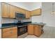 Bright kitchen with stainless steel appliances, natural wood cabinets, and a breakfast bar at 164 Chelsea Nw Ct, Port Charlotte, FL 33952