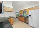 Bright kitchen with stainless steel appliances, natural wood cabinets, and a breakfast bar at 164 Chelsea Nw Ct, Port Charlotte, FL 33952