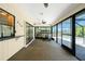 Enclosed sunroom with a serving window and views of the outdoor pool at 164 Chelsea Nw Ct, Port Charlotte, FL 33952