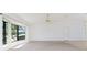 Bright and spacious living area features neutral carpet, a ceiling fan, and a bay window at 164 Chelsea Nw Ct, Port Charlotte, FL 33952