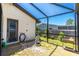 Outdoor patio with a rock garden and screened enclosure for bug-free enjoyment at 164 Chelsea Nw Ct, Port Charlotte, FL 33952