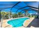 Enclosed pool with clear blue water and an ample deck area for entertaining at 164 Chelsea Nw Ct, Port Charlotte, FL 33952