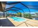 Backyard pool is surrounded by a screened enclosure and lush greenery at 164 Chelsea Nw Ct, Port Charlotte, FL 33952