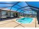 Backyard pool features screened enclosure and easy access to the main house at 164 Chelsea Nw Ct, Port Charlotte, FL 33952