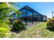 Outdoor screened pool surrounded by a fenced yard and green vegetation at 164 Chelsea Nw Ct, Port Charlotte, FL 33952
