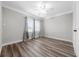 Nicely sized bedroom features wood-look floors, white trim, and neutral paint at 30087 Alder Rd, Punta Gorda, FL 33982