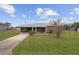 Charming single-story home featuring a screened porch and landscaped front yard at 30087 Alder Rd, Punta Gorda, FL 33982