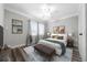 Staged primary bedroom with neutral paint, wood floors, and contemporary furniture at 30087 Alder Rd, Punta Gorda, FL 33982